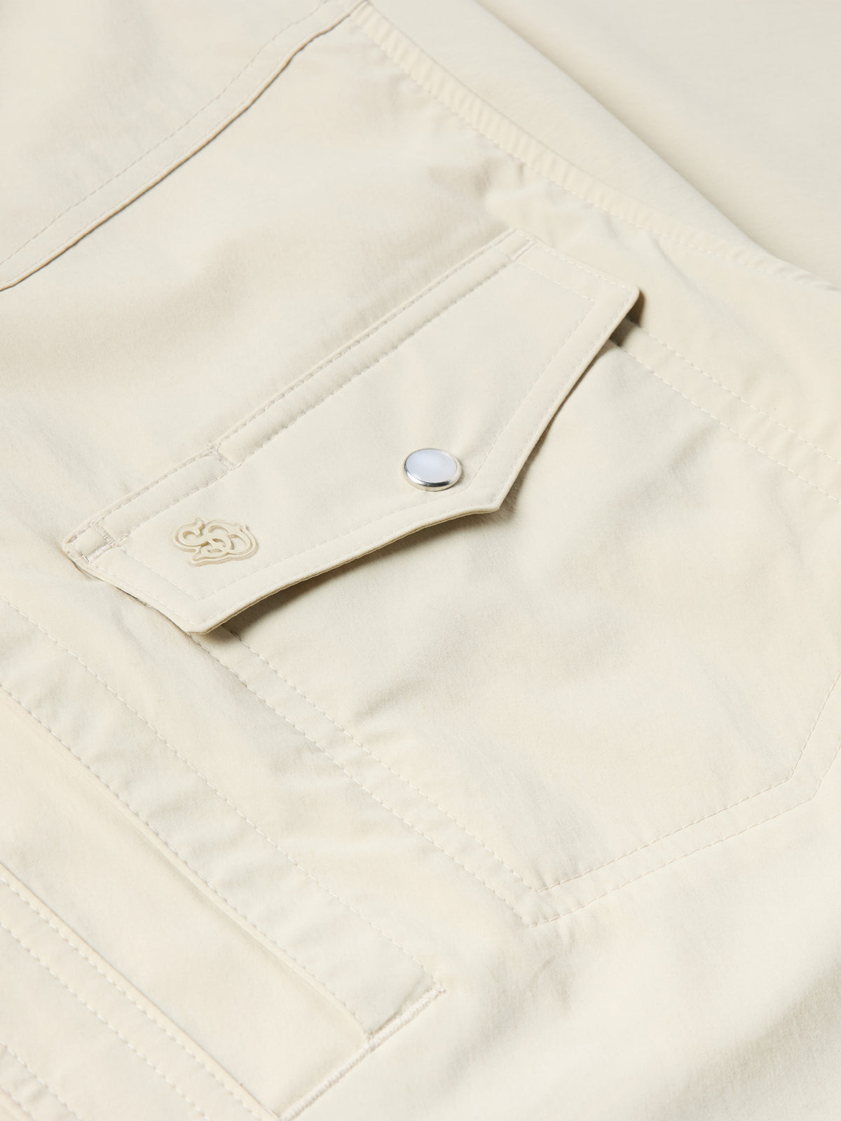 Khaki Western snap shirt chest pocket with snap tab and small stitched emblem