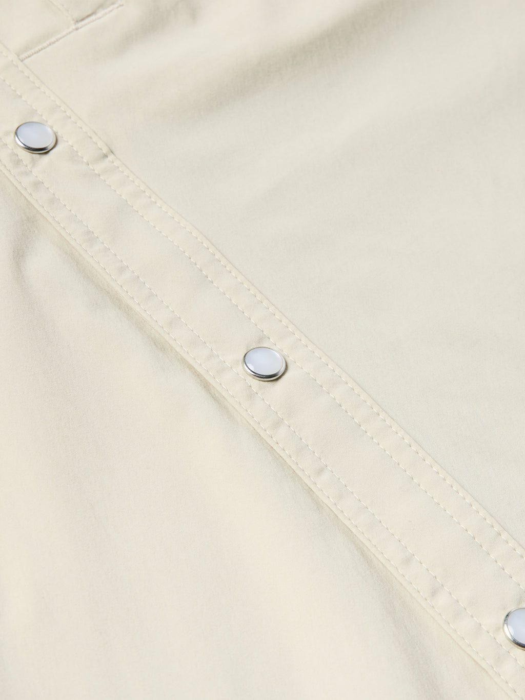 Khaki Western snap shirt with buttoned placket and diagonal stitch lines