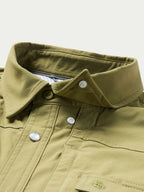 Olive short-sleeve snap western shirt close-up of chest yoke, button snaps, pocket