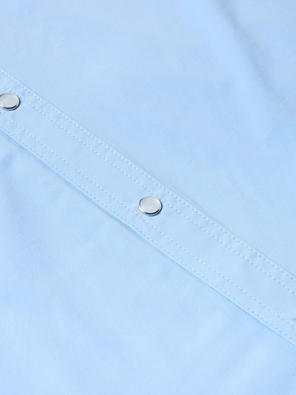 Light blue short-sleeve snap shirt placket with metal snaps and stitched seams