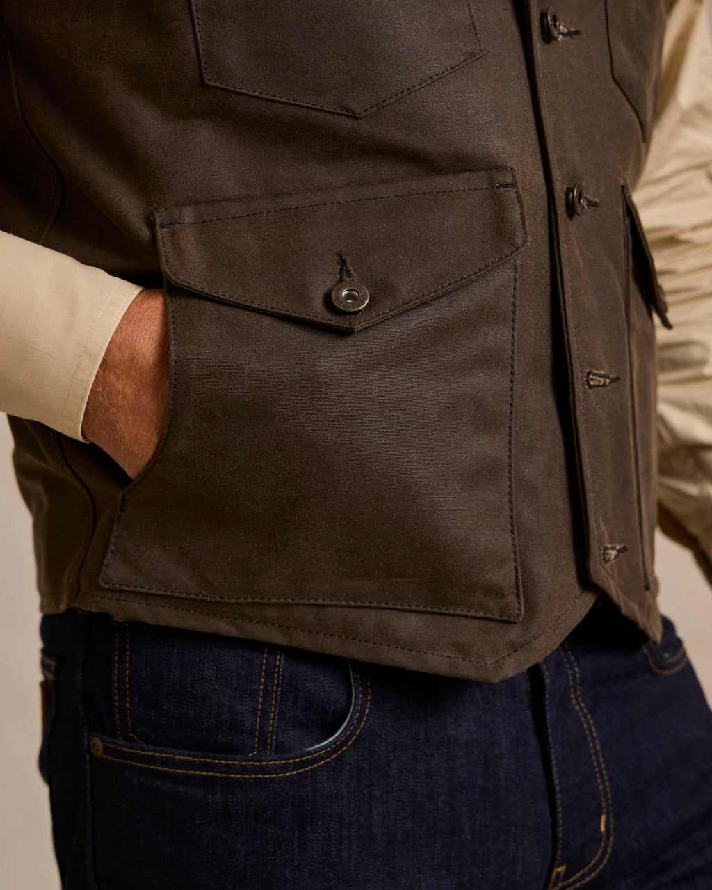 Dark brown vest front with large patch pocket and metal snap details