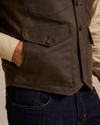 Dark brown vest front with large patch pocket and metal snap details