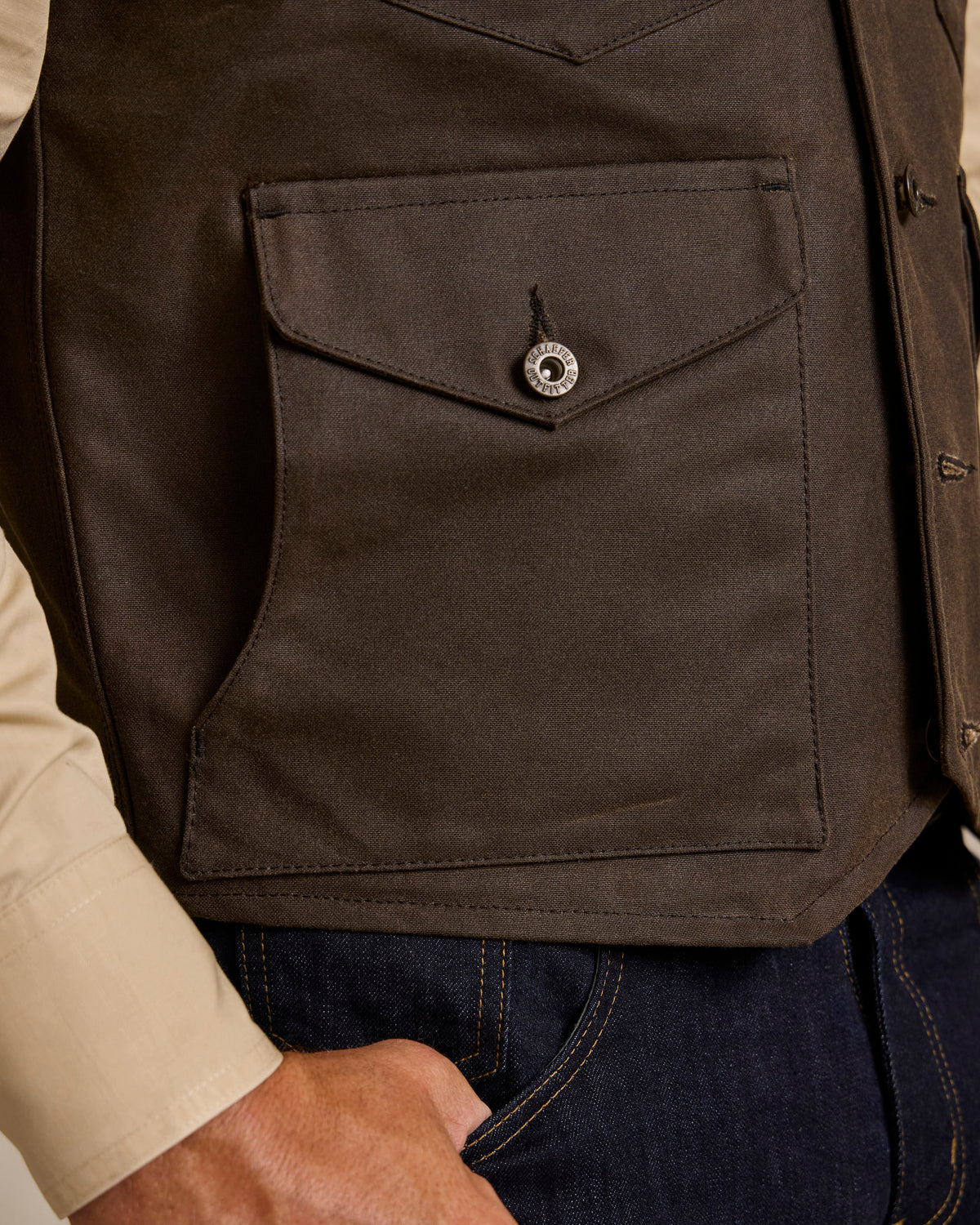 Dark brown vest with square patch pocket and metal snap button