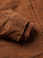 Russet canvas cuff close-up with ribbed sleeve hem and zipper placket