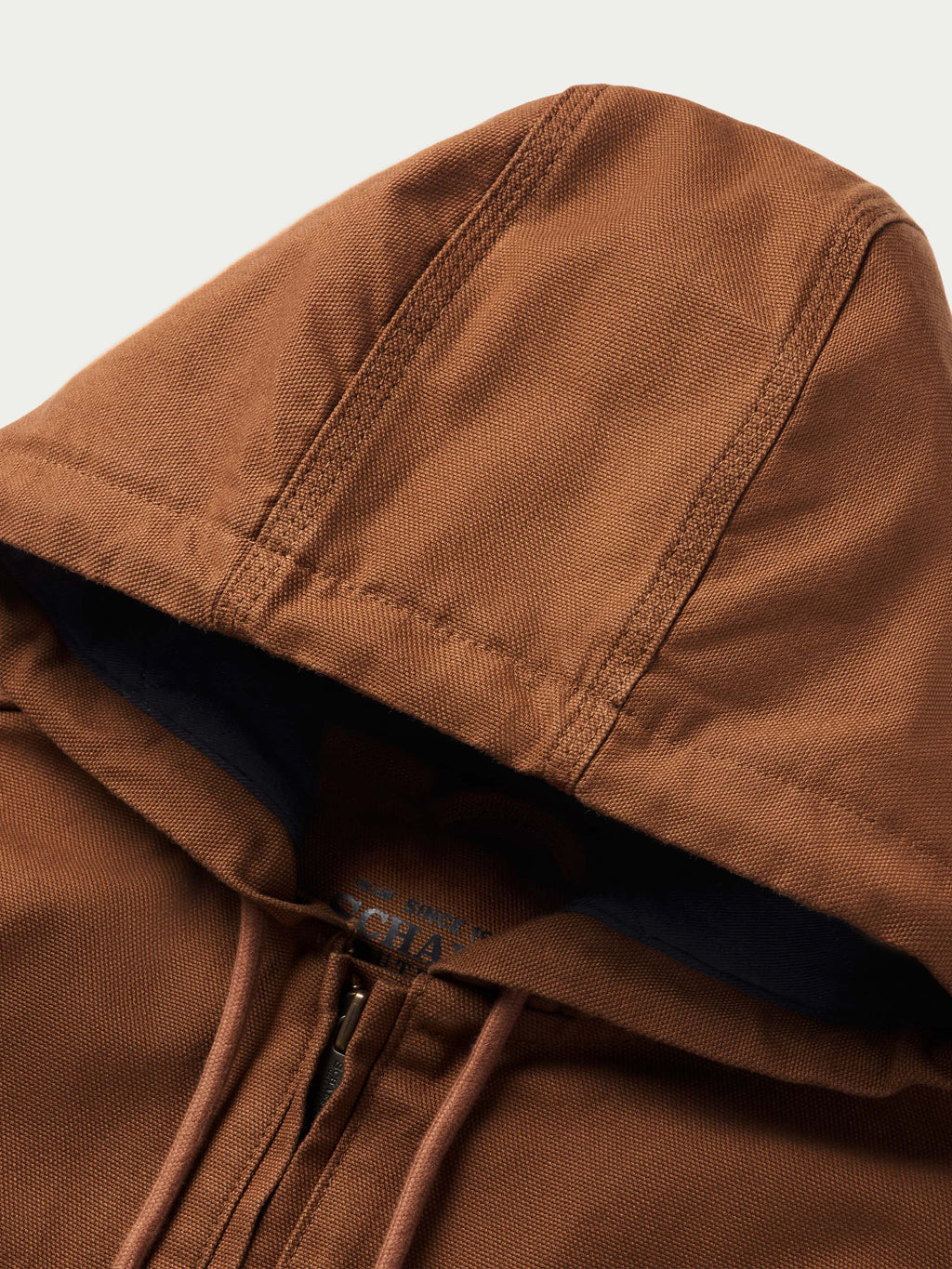 Russet hood edge close-up with navy lining and drawstring cords