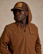 Men's russet hooded zip canvas jacket, close-up of zipper and chest pocket