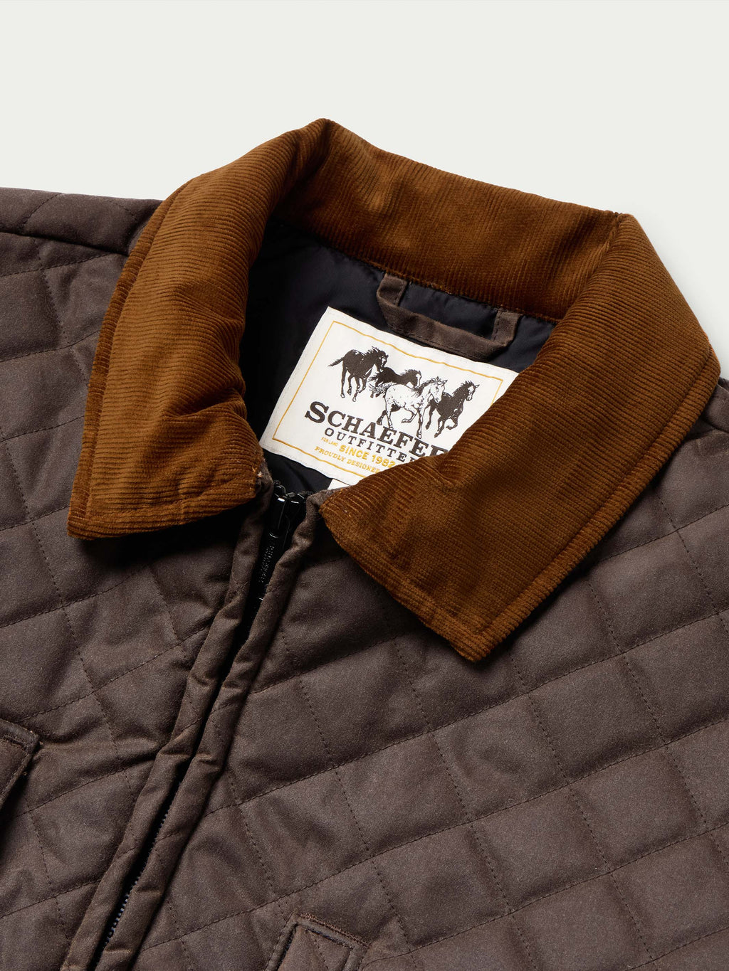Dark brown quilted jacket with tan corduroy collar and brand logo patch