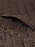 Dark brown quilted jacket with black zipper detail at side opening