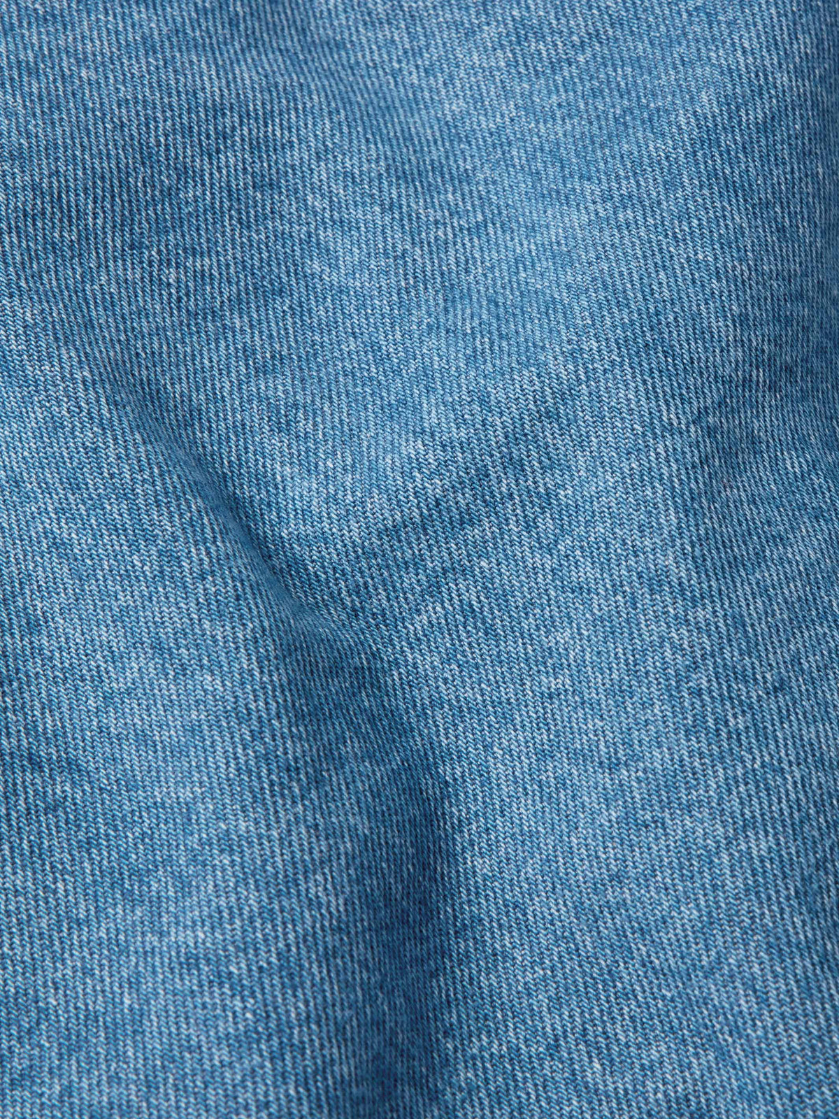 Medium indigo denim fabric close-up texture