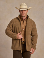 Taupe full-zip fleece jacket worn with visible zip front and pockets