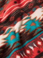 Aztec-inspired fleece fabric with red, brown, cream, and turquoise details