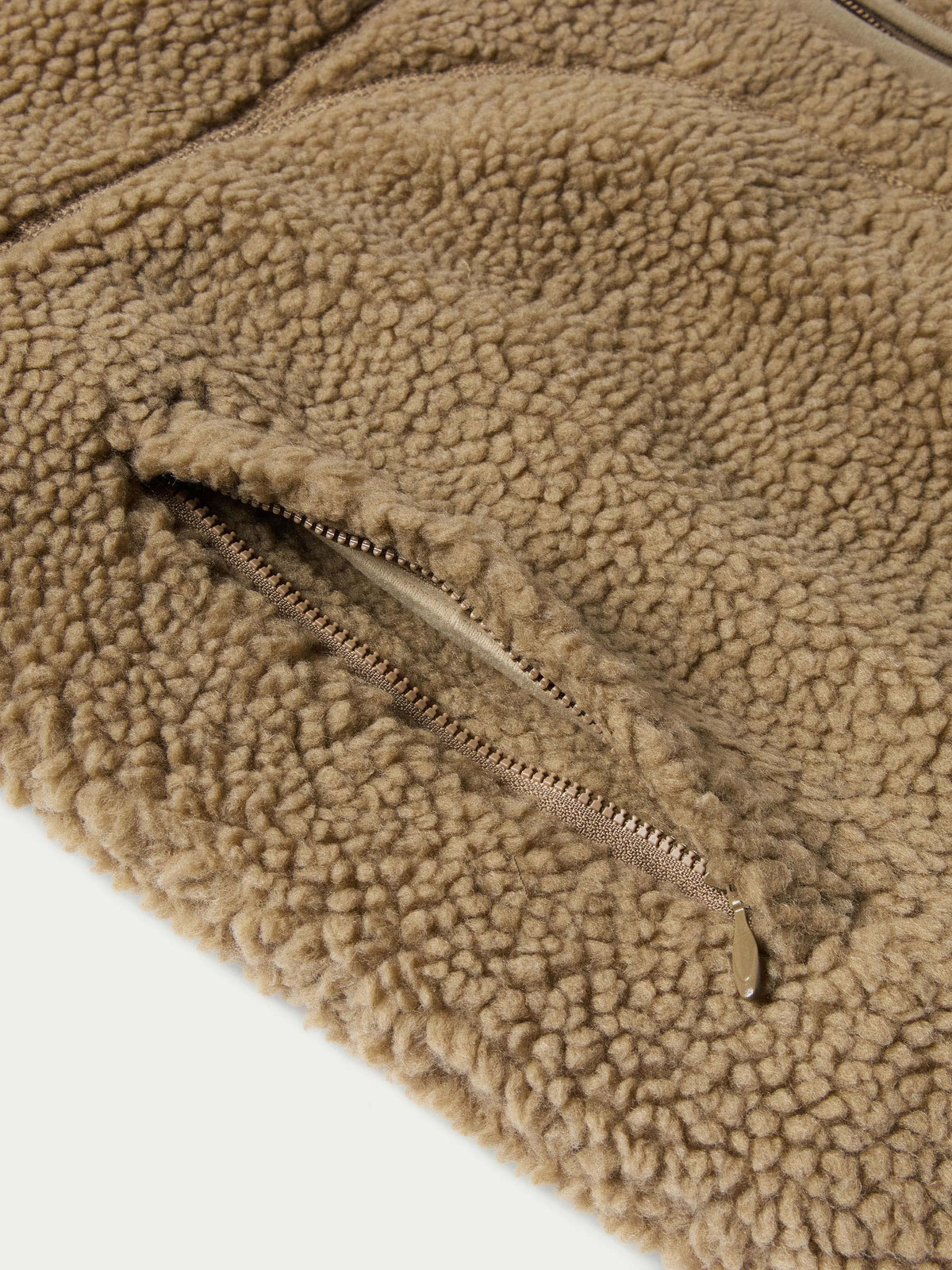 Taupe fleece jacket hem with metal zipper