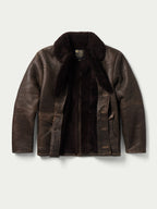 Shearling leather coat with dark fur collar, button front, and open chest