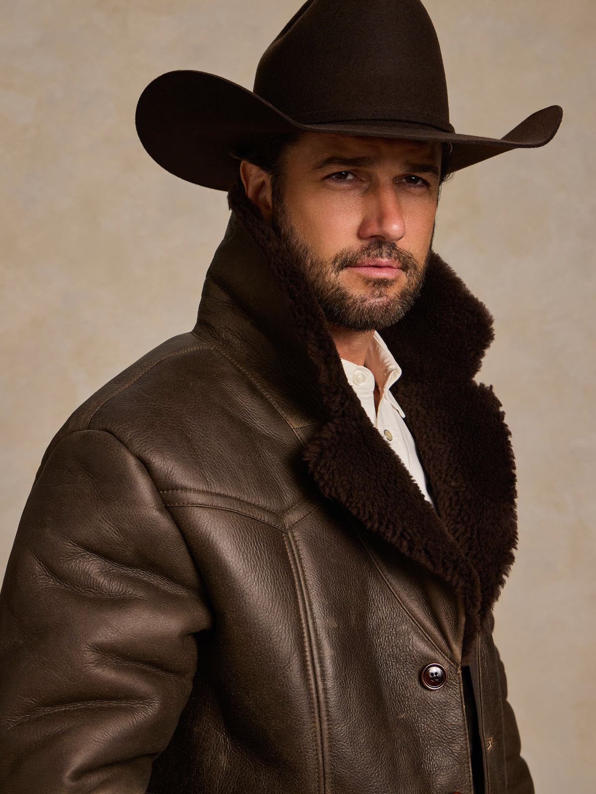 Men's dark brown shearling coat with shearling collar and buttoned front