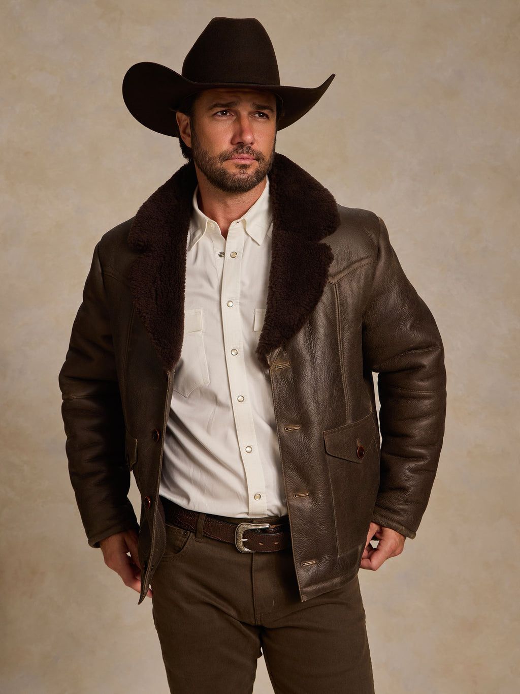 Men's dark brown shearling coat with thick fur collar and front snap pockets