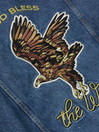 Close-up of eagle artwork and “the West” lettering on denim jacket back