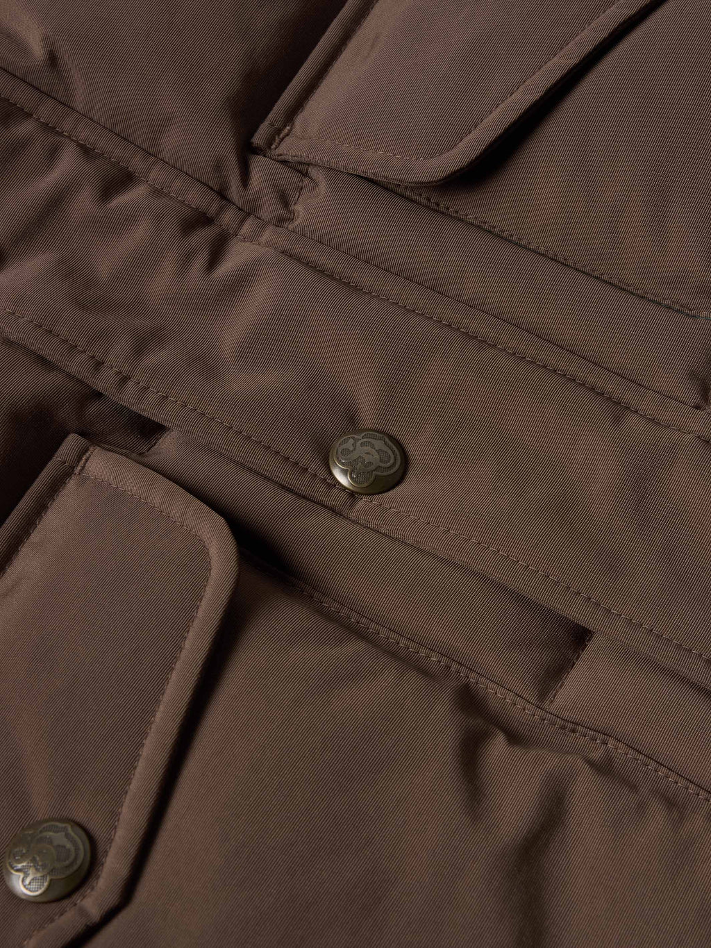 Bozeman down vest close-up of brown placket with snap buttons