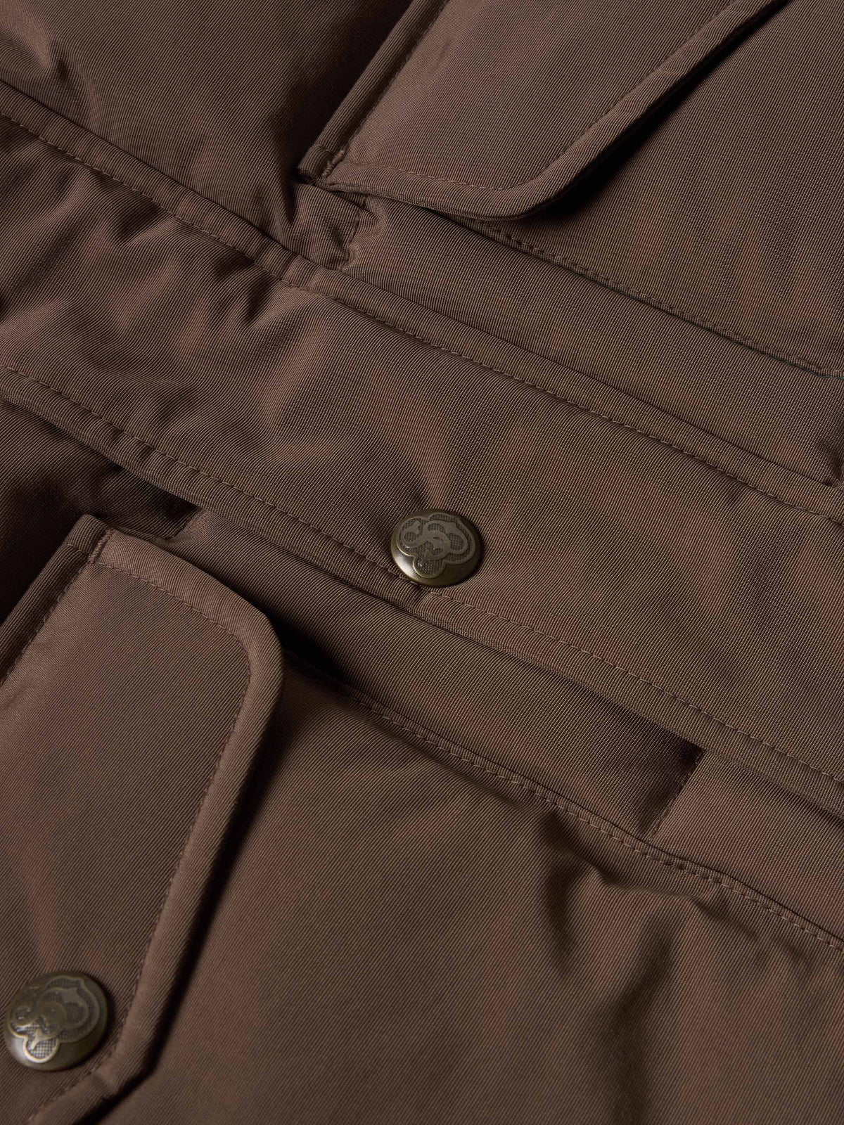 Bozeman down vest close-up of brown placket with snap buttons