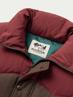 Bozeman down vest open showing teal lining and Schaefer Outfitters patch