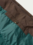 Bozeman down vest close-up of teal lining panel with brown trim and snaps