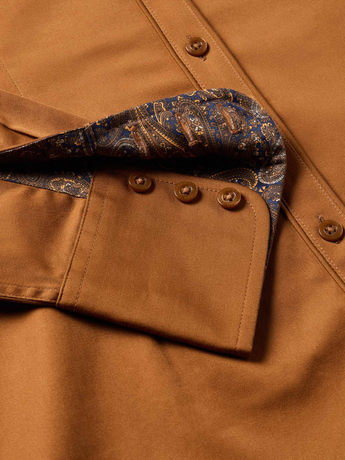 Women’s dark caramel button-up shirt with paisley lining at cuffs and button placket