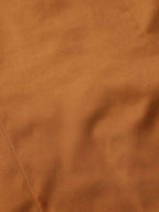 Dark caramel shirt fabric texture close-up