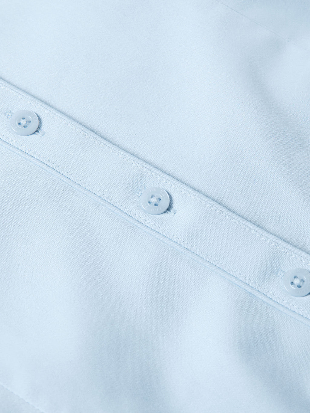 Light blue Reata button-up shirt front close-up with two visible placket buttons