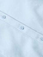 Light blue Reata button-up shirt front close-up with two visible placket buttons
