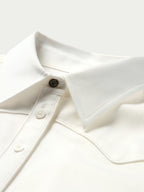 White button-up shirt neckline with pointed collar and long-sleeve placket buttons