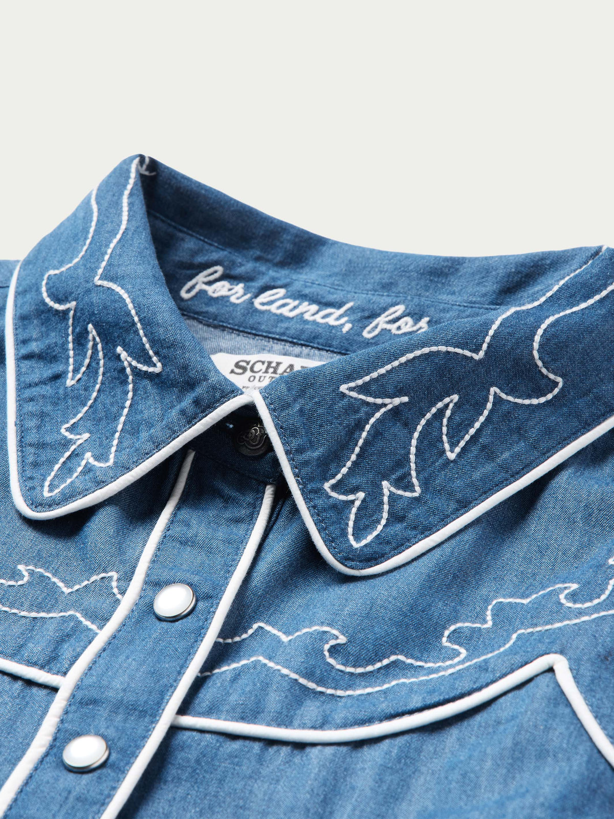 Chambray shirt collar with white embroidery and button placket detail