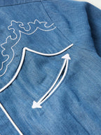 Chambray shirt shoulder yoke with white curved trim embroidery