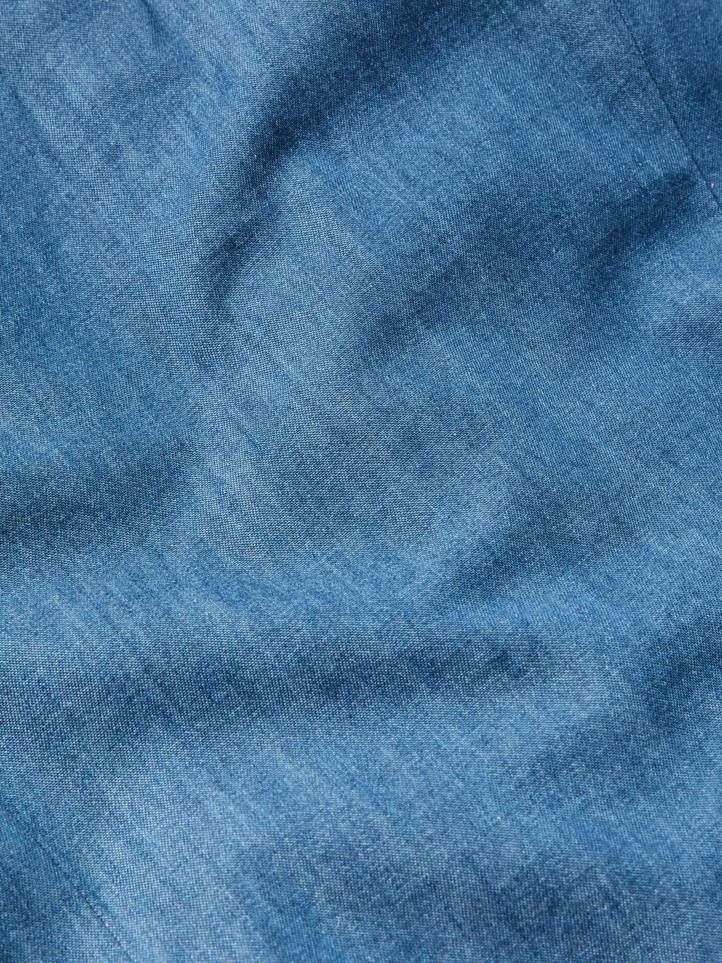 Chambray fabric texture swatch in blue with subtle woven grain