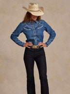 Embroidered chambray button-up shirt with white trim worn with jeans