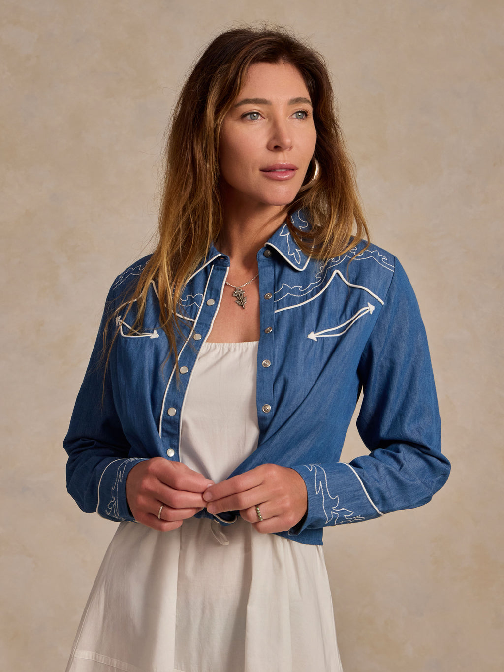 Embroidered chambray shirt with white collar trim, worn with light dress layer