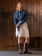 Chambray embroidered denim button-up shirt with long sleeves and curved yoke stitching