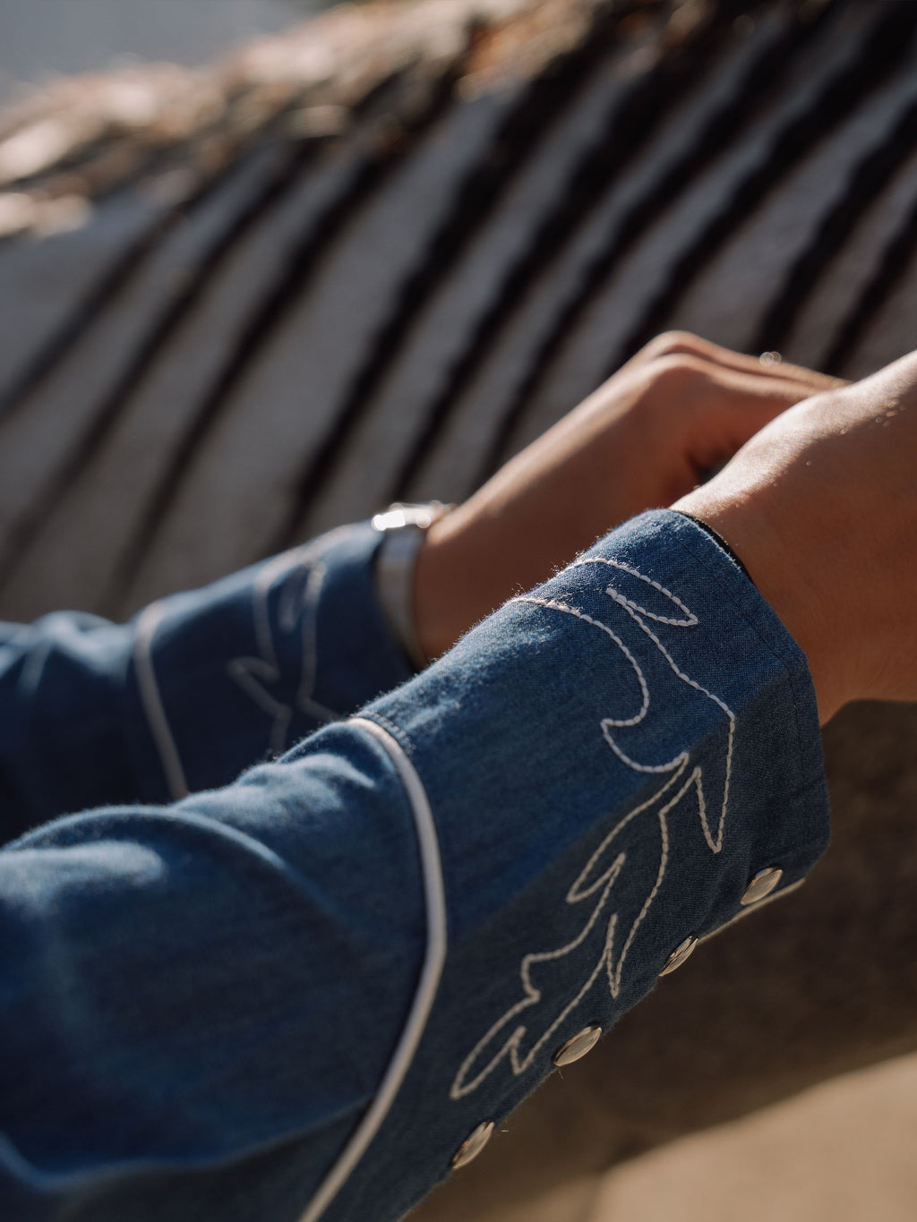 Embroidered chambray shirt sleeve cuff with contrast white thread detailing