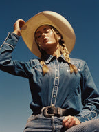 Embroidered chambray denim button-up shirt with long sleeves and white chest embroidery
