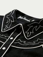 Women's embroidered Dale shirt with black fabric, white collar embroidery, and snap placket