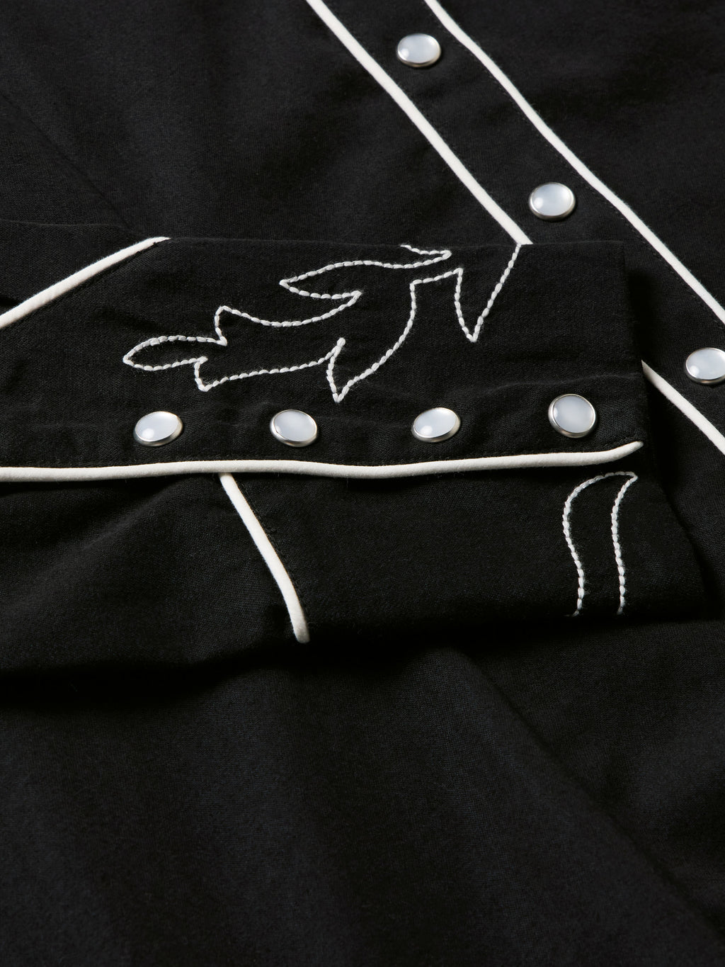 Women's embroidered Dale shirt detail showing white vine embroidery and silver-tone snaps