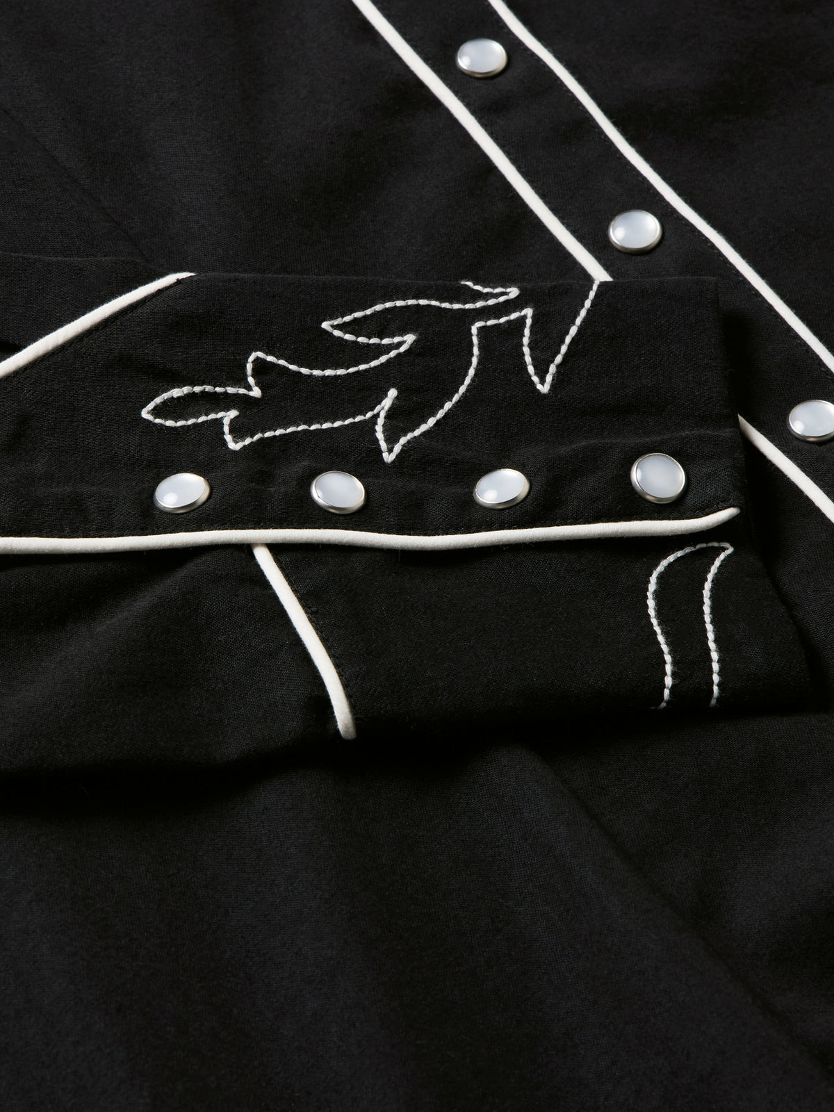 Women's embroidered Dale shirt detail showing white vine embroidery and silver-tone snaps