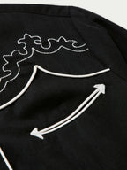 Women's embroidered Dale shirt close-up of white arrow embroidery on shoulder