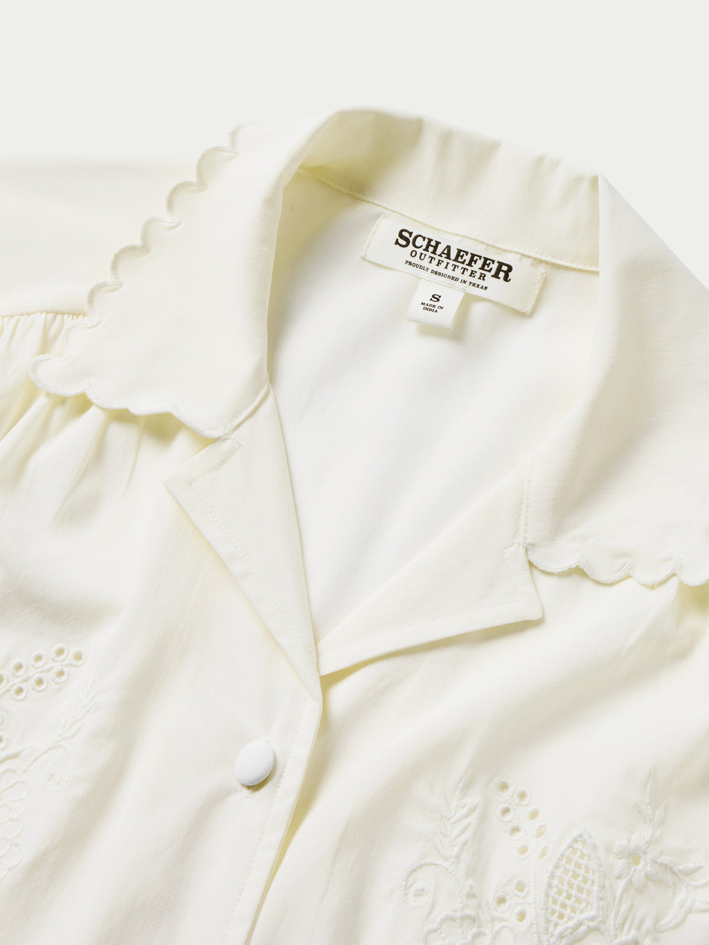 Vintage white blouse with scalloped collar trim, button placket, and embroidered accents