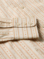 Women's printed button-up shirt front with button placket and patterned stripes