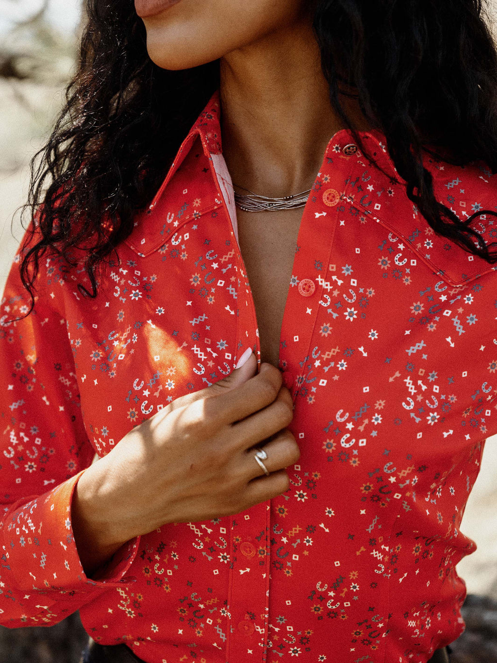 Red printed reata button-up shirt with open collar and top button visible
