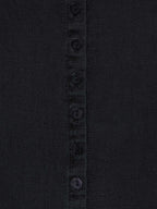 Washed black button-front dress placket close-up with round buttons