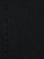 Washed black textured denim fabric with visible vertical seam