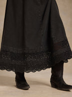 Washed black denim dress hem with scalloped lace trim and sparkling border