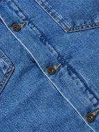 Indigo denim jacket chest detail with flap pockets and metal snap buttons