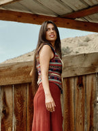 Women's patterned wool vest over white blouse; sleeveless tribal stripe design