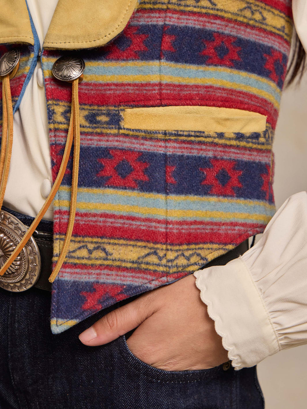 Wool vest with multicolor blanket stripe pattern and snap-front with lace trim